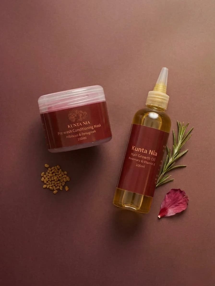 Kunta Nia Pre-wash Conditioning Mask jar and Hair Growth Oil bottle with fenugreek seeds, rosemary and a hibiscus petal