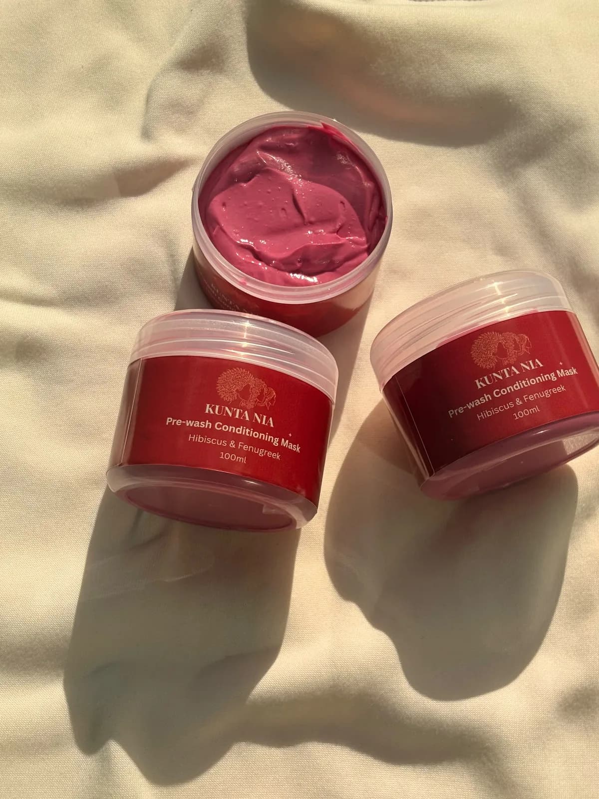 Two jars of Kunta Nia Pre-wash Conditioning Mask and an open jar showing the mask