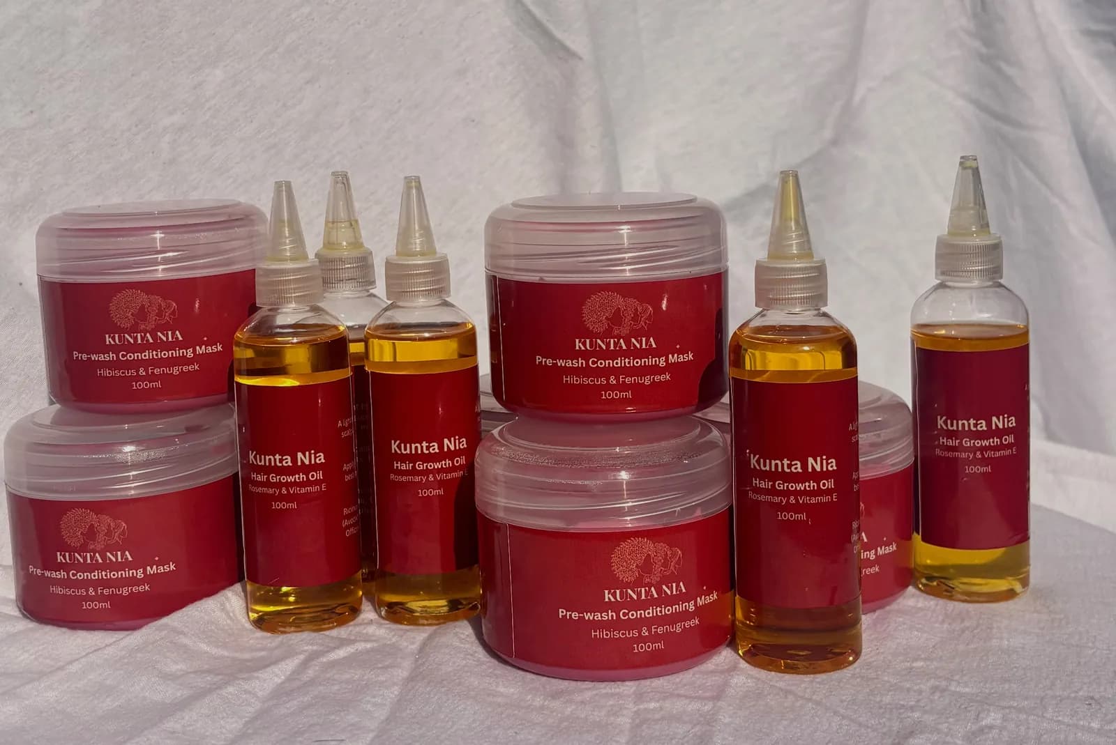 Kunta Nia Pre-wash Conditioning Mask jars and Hair Growth Oil bottles together